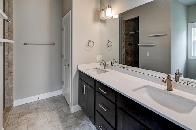 6586 Wolf Hollow Rd, Windsor, WI 53598 - full bathroom featuring double vanity, stone finish floors, and tiled shower