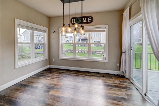 6586 Wolf Hollow Rd, Windsor, WI 53598 - unfurnished dining area featuring dark wood-style flooring and a chandelier