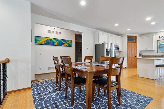 705 E Mason Dr, Edgerton, WI 53534 - dining area with light wood-style floors and recessed lighting