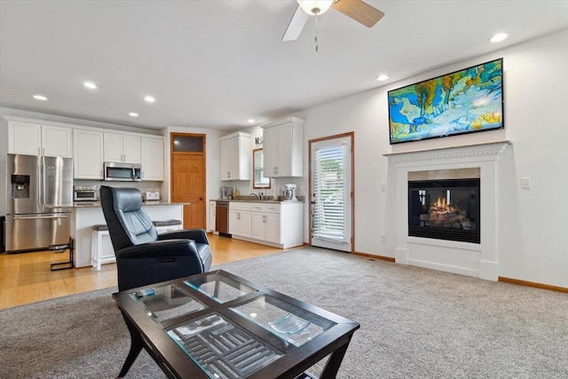 705 E Mason Dr, Edgerton, WI 53534 - living area with recessed lighting, light carpet, a ceiling fan, and a glass covered fireplace