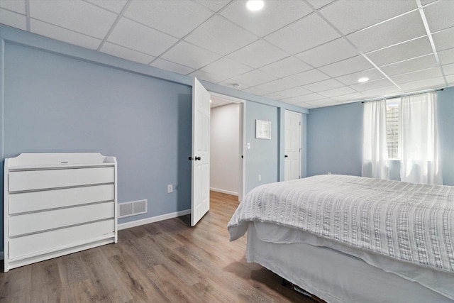705 E Mason Dr, Edgerton, WI 53534 - bedroom featuring wood finished floors and a drop ceiling