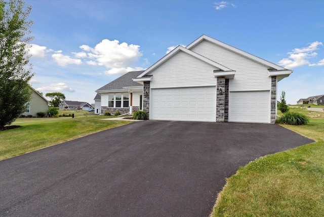 705 E Mason Dr, Edgerton, WI 53534 - view of front of home with driveway, a garage, stone siding, and a front lawn