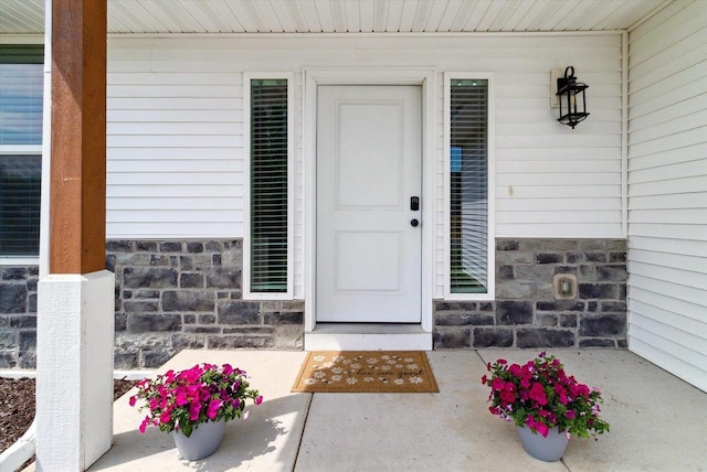 705 E Mason Dr, Edgerton, WI 53534 - view of exterior entry featuring stone siding and covered porch