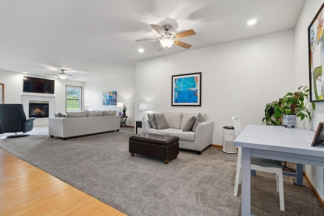 705 E Mason Dr, Edgerton, WI 53534 - living room featuring ceiling fan, a glass covered fireplace, recessed lighting, and wood finished floors