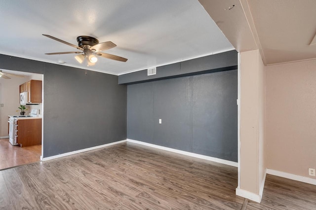 1413 Avon St, La Crosse, WI 54603 - unfurnished living room with a ceiling fan, wood finished floors, and ornamental molding