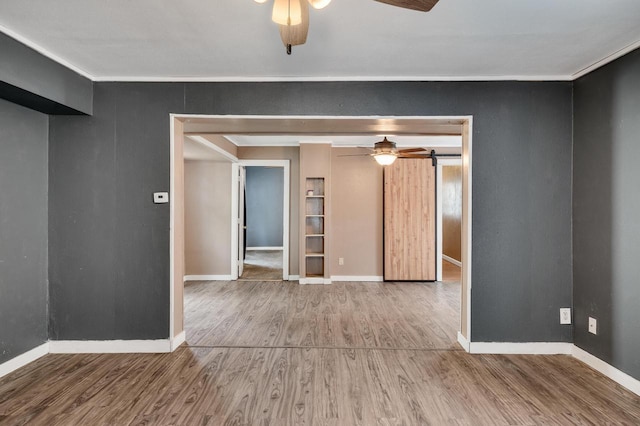 1413 Avon St, La Crosse, WI 54603 - spare room featuring a ceiling fan, wood finished floors, and built in features