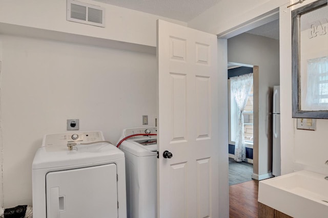 1413 Avon St, La Crosse, WI 54603 - washroom featuring dark wood-type flooring and washer and clothes dryer