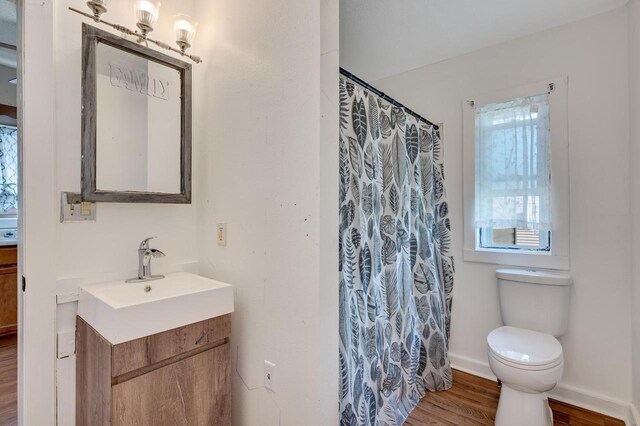 1413 Avon St, La Crosse, WI 54603 - bathroom with vanity, wood finished floors, and curtained shower
