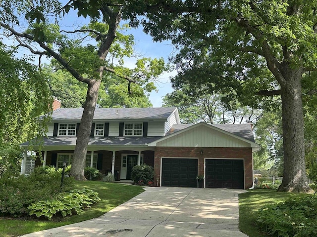 5026 Coney Weston Pl, Madison, WI 53711 - view of front of home featuring an attached garage, driveway, a front lawn, a chimney, and brick siding