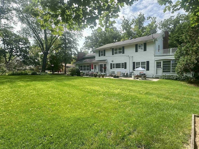 5026 Coney Weston Pl, Madison, WI 53711 - rear view of house with a patio area, a yard, a chimney, and a balcony
