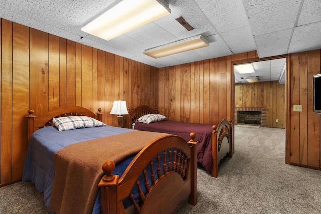 5026 Coney Weston Pl, Madison, WI 53711 - bedroom featuring carpet floors, wooden walls, and a fireplace