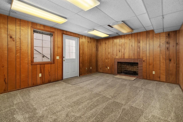 5026 Coney Weston Pl, Madison, WI 53711 - unfurnished living room with carpet, a fireplace, wood walls, and a paneled ceiling