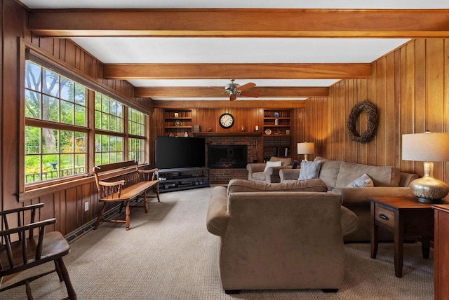 5026 Coney Weston Pl, Madison, WI 53711 - carpeted living area with wood walls, a ceiling fan, beam ceiling, a fireplace, and built in shelves