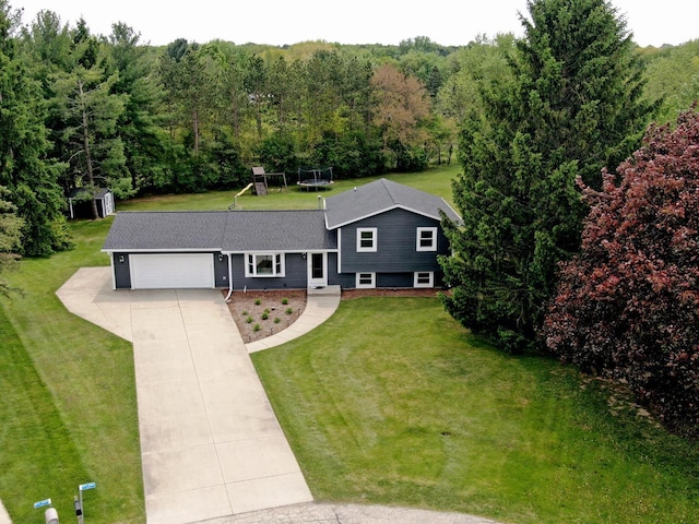 W355N5843 Bridle Ln, Oconomowoc, WI 53066 - view of front facade with a playground, concrete driveway, a garage, and a front yard