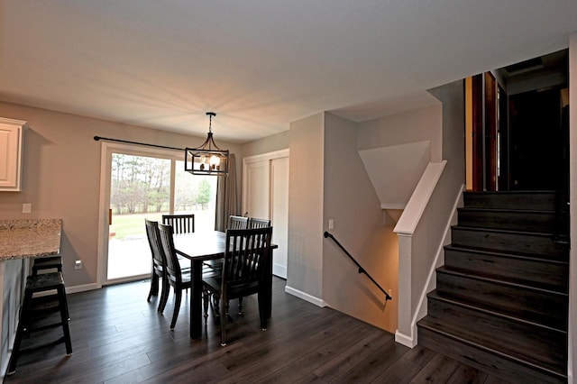 W355N5843 Bridle Ln, Oconomowoc, WI 53066 - dining space featuring dark wood-style floors, a chandelier, and stairs