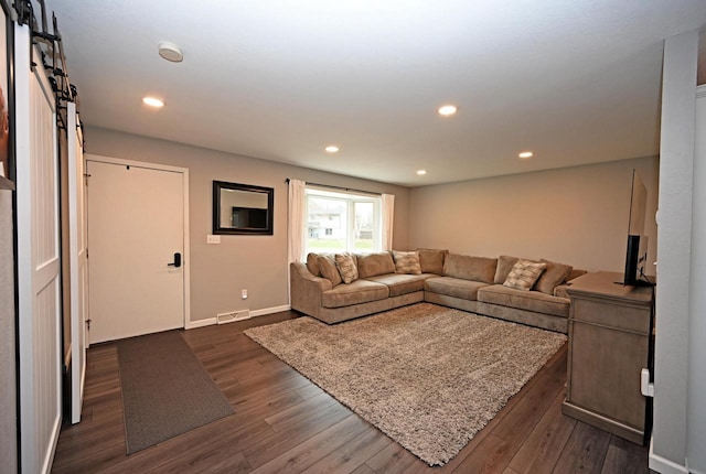 W355N5843 Bridle Ln, Oconomowoc, WI 53066 - living room featuring dark wood-style flooring, recessed lighting, and a barn door
