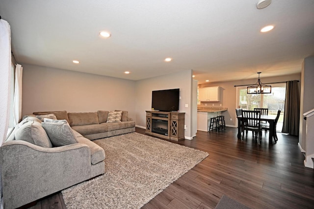 W355N5843 Bridle Ln, Oconomowoc, WI 53066 - living area with dark wood-style floors, a chandelier, and recessed lighting