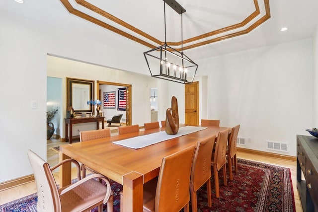 W332S9291 Red Brae Dr, Mukwonago, WI 53149 - dining room with wood finished floors, a raised ceiling, a chandelier, recessed lighting, and crown molding