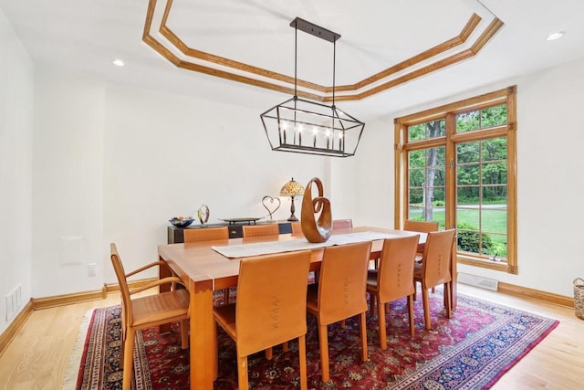 W332S9291 Red Brae Dr, Mukwonago, WI 53149 - dining area with a tray ceiling, light wood finished floors, crown molding, a chandelier, and recessed lighting