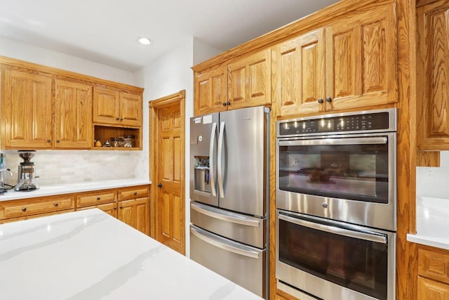 W332S9291 Red Brae Dr, Mukwonago, WI 53149 - kitchen featuring appliances with stainless steel finishes, backsplash, open shelves, recessed lighting, and brown cabinets