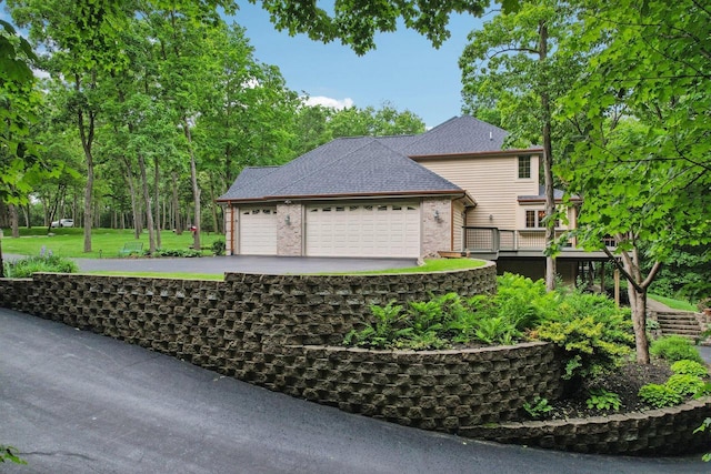 W332S9291 Red Brae Dr, Mukwonago, WI 53149 - view of home's exterior featuring a garage, brick siding, and driveway