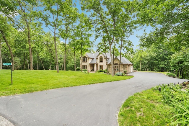 W332S9291 Red Brae Dr, Mukwonago, WI 53149 - view of front of property with a front yard, driveway, and stone siding