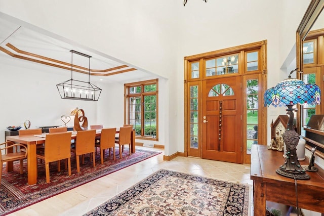 W332S9291 Red Brae Dr, Mukwonago, WI 53149 - entrance foyer featuring a tray ceiling, a chandelier, a towering ceiling, and tile patterned flooring