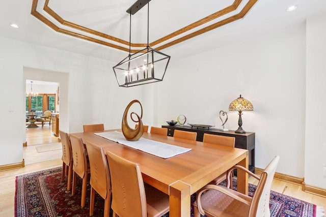 W332S9291 Red Brae Dr, Mukwonago, WI 53149 - dining area featuring a chandelier, a tray ceiling, recessed lighting, light wood-type flooring, and ornamental molding