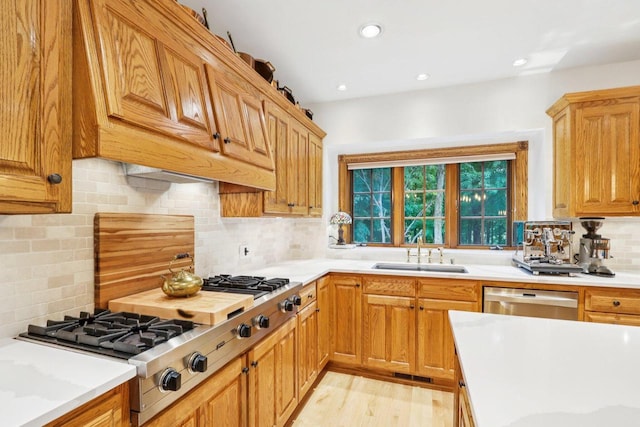 W332S9291 Red Brae Dr, Mukwonago, WI 53149 - kitchen featuring appliances with stainless steel finishes, tasteful backsplash, light countertops, light wood finished floors, and recessed lighting