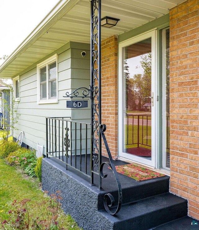 6D Hayes Ct, Superior, WI 54880 - property entrance featuring covered porch and brick siding