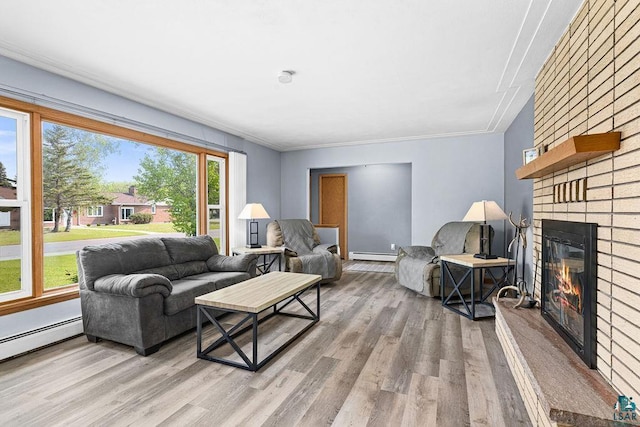 6D Hayes Ct, Superior, WI 54880 - living area featuring a brick fireplace, baseboard heating, wood finished floors, and ornamental molding