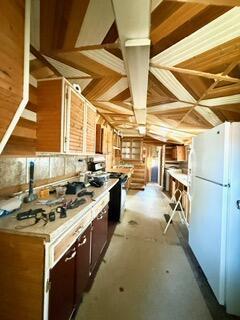 807 Charles St, La Crosse, WI 54603 - kitchen with freestanding refrigerator, light countertops, and concrete flooring