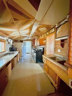 807 Charles St, La Crosse, WI 54603 - kitchen featuring range, light countertops, and brown cabinetry