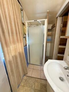 807 Charles St, La Crosse, WI 54603 - bathroom featuring a shower stall and stone tile flooring