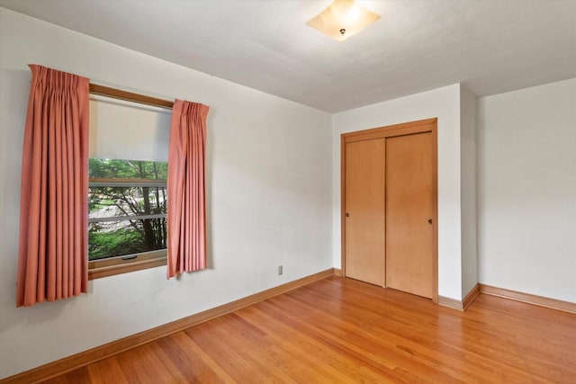 3669 S Quincy Ct, Milwaukee, WI 53207 - unfurnished bedroom featuring light wood-style floors and a closet