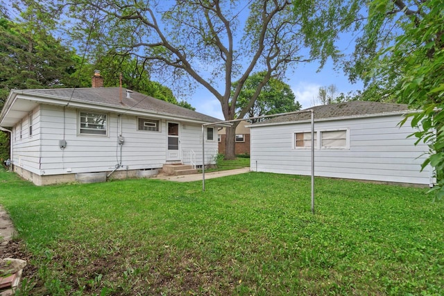 3669 S Quincy Ct, Milwaukee, WI 53207 - back of property with entry steps, a chimney, and a yard