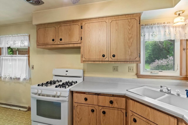 3669 S Quincy Ct, Milwaukee, WI 53207 - kitchen featuring white gas range oven, a baseboard heating unit, light countertops, and tile patterned floors