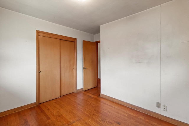 3669 S Quincy Ct, Milwaukee, WI 53207 - unfurnished bedroom with wood finished floors and a closet