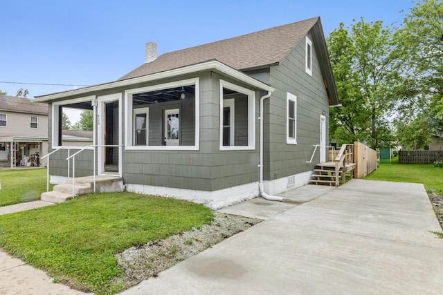 429 W Juneau St, Tomah, WI 54660 - view of front facade featuring a chimney and roof with shingles