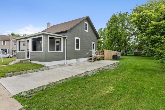 429 W Juneau St, Tomah, WI 54660 - view of property exterior featuring a chimney and a yard