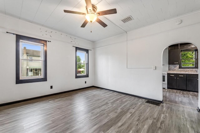 429 W Juneau St, Tomah, WI 54660 - unfurnished room with crown molding, wood finished floors, arched walkways, a ceiling fan, and a smoke detector