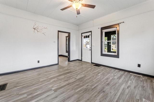 429 W Juneau St, Tomah, WI 54660 - empty room with wood finished floors, a ceiling fan, and ornamental molding