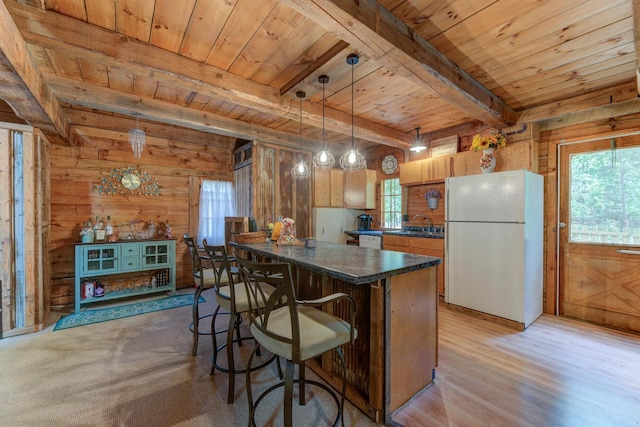 W3562 Glencoe Ave, Montello, WI 53949 - kitchen with freestanding refrigerator, a wooden ceiling with exposed beams, wooden walls, dark countertops, and plenty of natural light