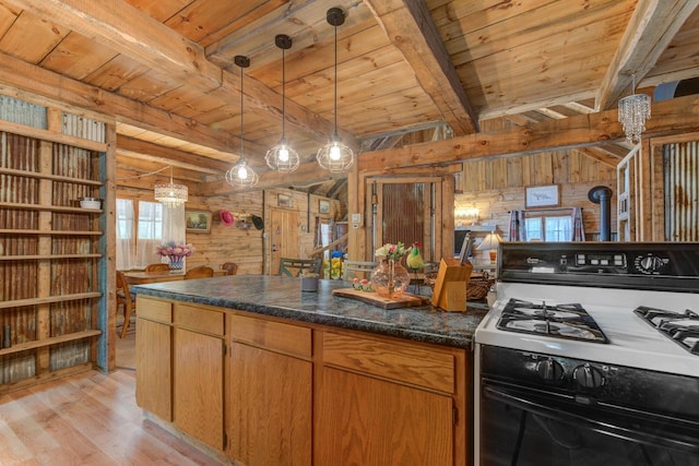 W3562 Glencoe Ave, Montello, WI 53949 - kitchen featuring gas range, wood walls, a wooden ceiling with exposed beams, light wood-style flooring, and decorative light fixtures