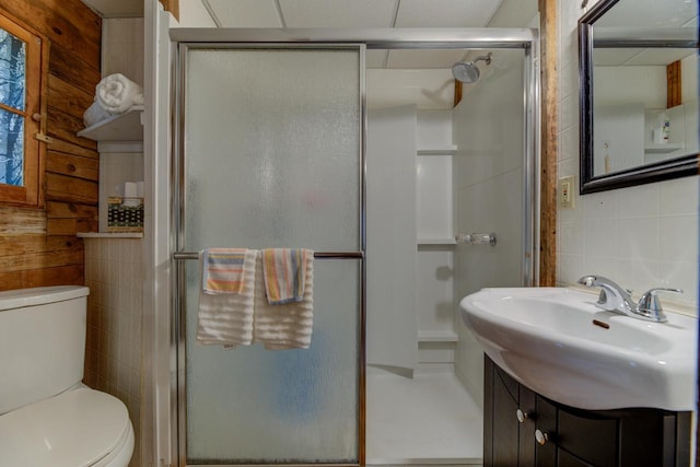 W3562 Glencoe Ave, Montello, WI 53949 - bathroom featuring tile walls, a stall shower, vanity, and backsplash
