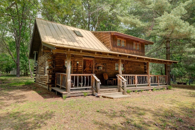 W3562 Glencoe Ave, Montello, WI 53949 - log home featuring log siding, a standing seam roof, and a metal roof