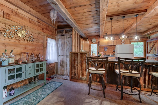 W3562 Glencoe Ave, Montello, WI 53949 - indoor dry bar featuring freestanding refrigerator, a wooden ceiling with exposed beams, wooden walls, carpet flooring, and decorative light fixtures