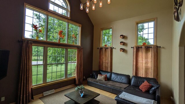 N100W17560 Whitetail Run, Germantown, WI 53022 - living area with high vaulted ceiling, wood finished floors, and a chandelier