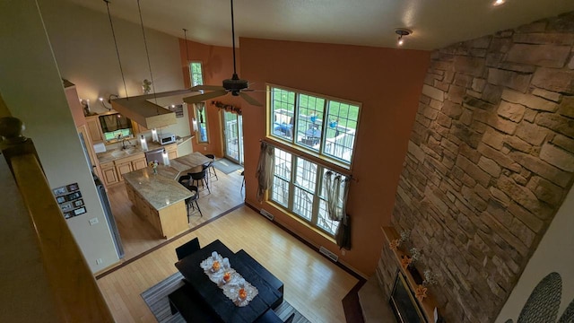 N100W17560 Whitetail Run, Germantown, WI 53022 - living room with high vaulted ceiling, plenty of natural light, light wood-type flooring, and ceiling fan