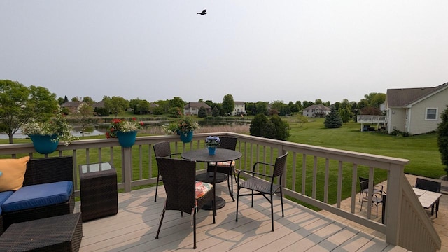 N100W17560 Whitetail Run, Germantown, WI 53022 - wooden terrace featuring outdoor dining space, a lawn, and a water view